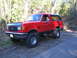 1989 Ford Bronco - This red Ford Bronco appears to be from the late 1980s, not 1989, based on its body style.