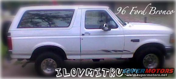 Side view of a white 1996 Ford Bronco with aftermarket decals on the lower body