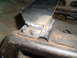 1996 Dodge 2500 - A metal bracket has been welded to the seat frame, showing visible weld marks and rust.