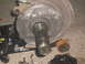 1996 Dodge 2500 - Front wheel hub assembly, likely removed for repair or replacement, with parts on the ground.