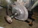 1996 Dodge 2500 - Close-up of a vehicle's rear axle and brake components, supported by a jack.