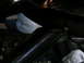 1989 Ford Escort - Detail shot of an unidentified car interior component, focus on dark metal structure.