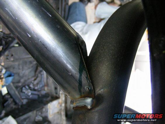 Close-up of welded roll cage tubing inside a vehicle