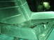 1989 Ford Escort - A metallic car part is shown with a rotary tool on its surface.