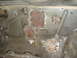 1989 Ford Escort - This photo shows several metal patches that have been welded onto the floor pan of a vehicle.