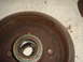1989 Ford Escort - Close-up of a corroded brake drum, showing wear and a bearing assembly.