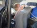1989 Ford Escort - A young person is focused on working inside a vehicle's cabin with a diagnostic tool.