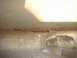 1989 Ford Escort - The underside of a vehicle shows significant rust and corrosion on its frame.