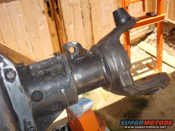 Ford Bronco front axle knuckle assembly, black metal, on orange stand