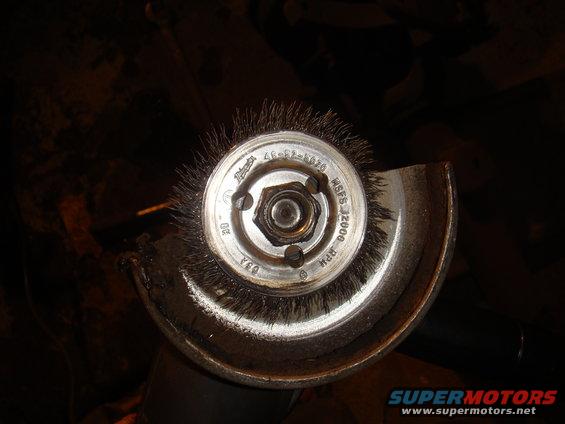 Wire wheel brush on angle grinder, with text indicating 12000 RPM