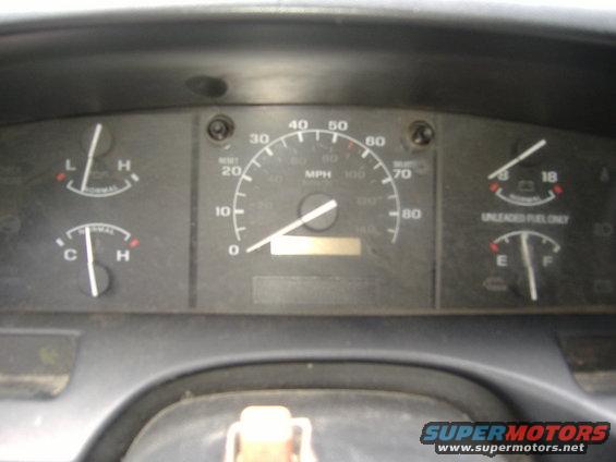 Dashboard with speedometer, fuel gauge, oil pressure, and temperature gauges. Speedometer reads under 20 mph