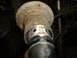 1995 Ford F-150 - Close-up of a rusted metal pipe fitting with visible holes and a black rubber seal.