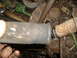 1995 Ford F-150 - A close-up view of a vehicle's exhaust pipe, showing signs of rust and a clamp connection.