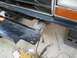 1991 Ford Explorer - Repairing a bumper bracket with welding equipment and tools nearby.