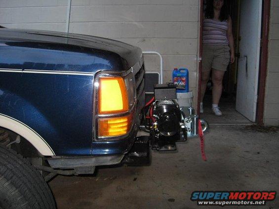 Blue 1992 Ford F-150 front bumper with a winch attached