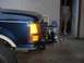 1991 Ford Explorer - A blue 1992 Ford F-150's front end is visible, equipped with a winch mounted below the bumper.
