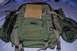 1991 Ford Bronco - Green tactical backpack with multiple compartments and straps, placed on a blue surface.