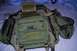 1991 Ford Bronco - A green tactical backpack with various compartments and MOLLE webbing is displayed on a bed.