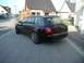 2003 Audi A6 - Rear view of a black 2003 Audi A6 wagon parked in front of a house.