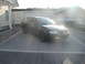 2003 Audi A6 - A dark colored Audi A6 Avant is parked in a paved driveway in front of a house and garage.