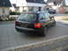 2003 Audi A6 - This black Audi A6 wagon is seen from the rear, parked on a paved driveway with a modern house in the background.