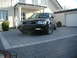 2003 Audi A6 - A black 2003 Audi A6 Avant is parked in a driveway in front of a house.