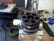 1996 Ford Bronco - A 'SWAY-A-WAY' hydraulic pump part is clamped in a vise, with shop tools in the background.