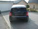2001 Audi A4 - Black Audi A2 hatchback parked in front of a garage and house.