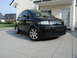 2001 Audi A4 - A black hatchback with a unique body style is parked in front of a modern house.