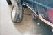 1994 Ford Bronco - The rear axle has broken off on this SUV, leaving the wheel detached.