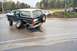 1994 Ford Bronco - A Ford Bronco, likely from the early to mid-1990s, sits with its rear axle damaged and a wheel detached.