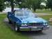 1973 Ford Ranchero - This blue Ford Ranchero is seen from a three-quarter front view, parked outdoors near a body of water.