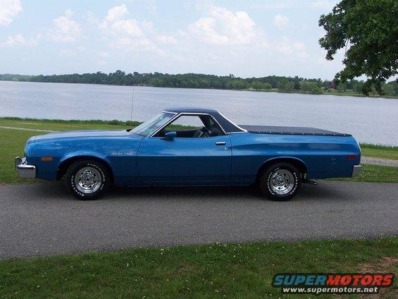 Blue 1973 Ford Ranchero parked by a lake, side view