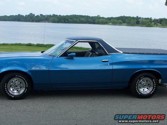 Blue 1973 Ford Ranchero side view with a black vinyl top