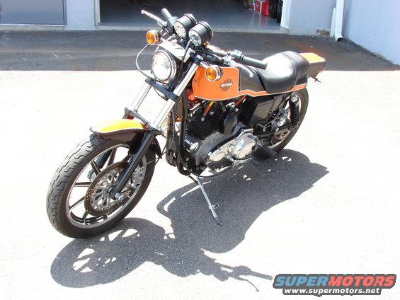 Orange and black Harley-Davidson motorcycle parked outside