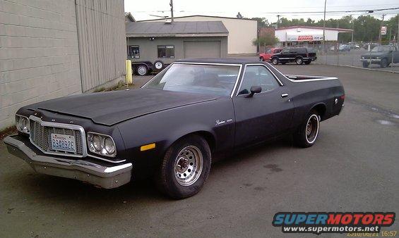 Dark blue 1976 Ford Ranchero with a matte black hood and chrome grille