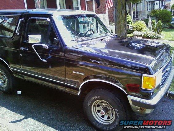 1990 Ford Bronco parked on a driveway, front 3/4 view