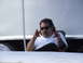 1990 Ford Mustang - A man sits inside a trailer, looking towards the camera with his hands raised.