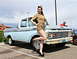 1963 Ford F-100 - A pin-up model poses next to a classic Ford pickup truck, which appears to be from the mid-1960s.