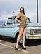 1963 Ford F-100 - A woman poses next to a light blue pickup truck, which appears to be from the mid-1960s.