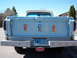1963 Ford F-100 - Rear view of a light blue 1963 Ford F-100 pickup truck with awareness ribbons on the tailgate.