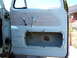 1963 Ford F-100 - The interior of a truck door is visible, with a person standing behind it.