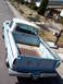 1963 Ford F-100 - This pickup truck has a white camper shell and a faded blue exterior with some rust in the bed.