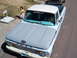 1963 Ford F-100 - This 1963 Ford F-100 pickup truck is seen from a high angle, with a young girl playing nearby.