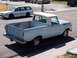 1963 Ford F-100 - This light blue 1963 Ford F-100 pickup truck is seen from a 3/4 front angle.