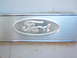 1963 Ford F-100 - Close-up of a Ford oval emblem on a metal surface.
