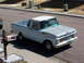 1963 Ford F-100 - A light blue and white 1961 Ford F-100 pickup truck is parked on a residential street.