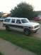 1989 Ford C-350 (Centurion Conversions) - This two-tone SUV features a prominent maroon stripe and appears to be from the late 1980s.