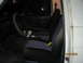 1989 Ford Bronco - The interior of a 1989 Ford Bronco, dark seats with blue accents and a visible steering wheel.