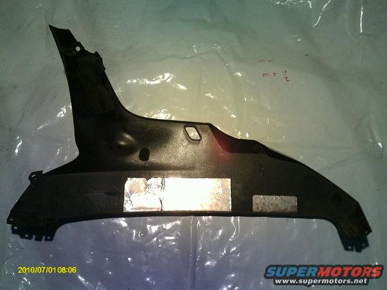 Black plastic body panel with silver tape on it